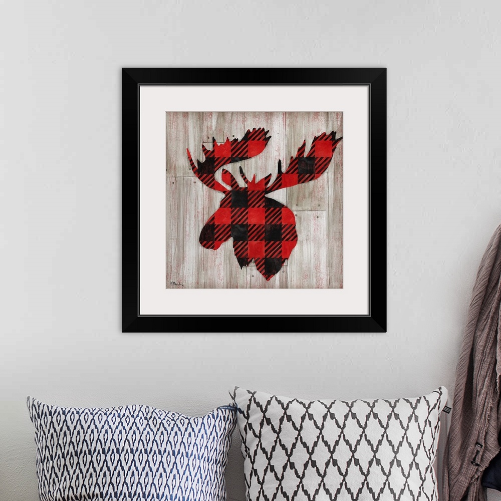 A bohemian room featuring Square cabin decor with a red and black flannel patterned silhouette of a moose on a faux distres...