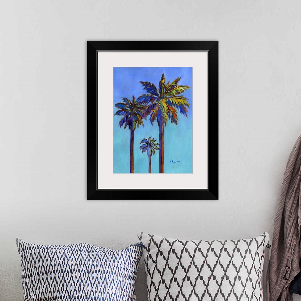A bohemian room featuring Contemporary painting of three palm trees against a bold blue sky.