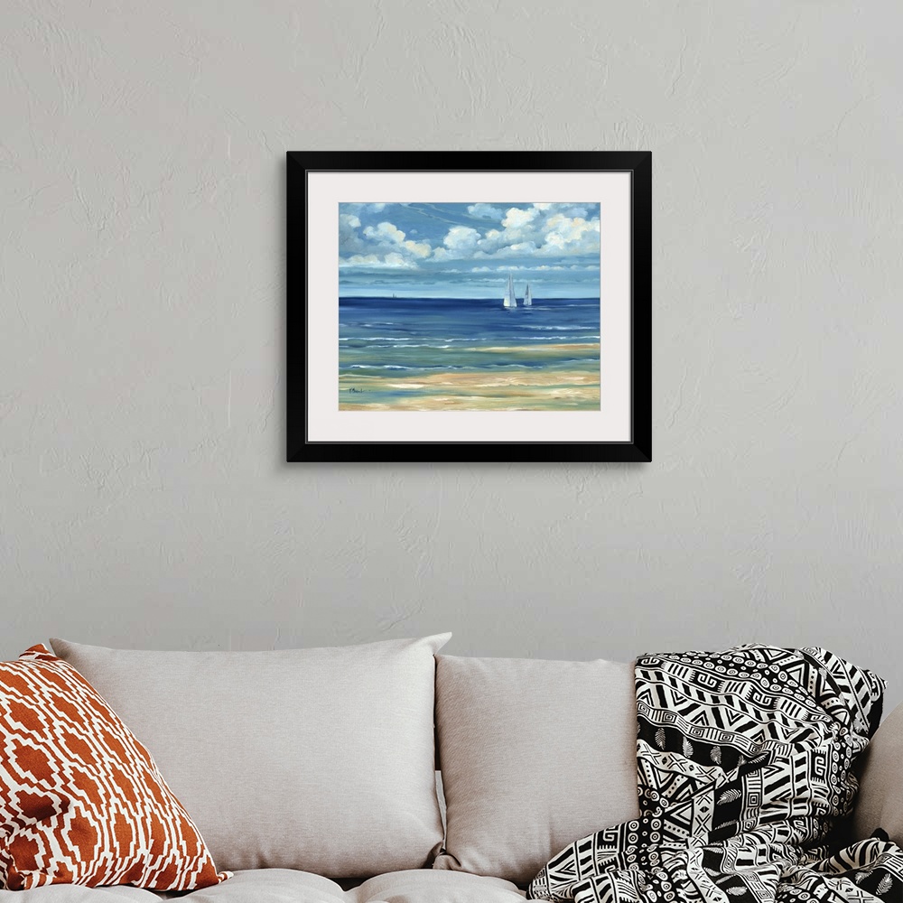 A bohemian room featuring Contemporary landscape painting of a deep blue ocean with white clouds overhead.