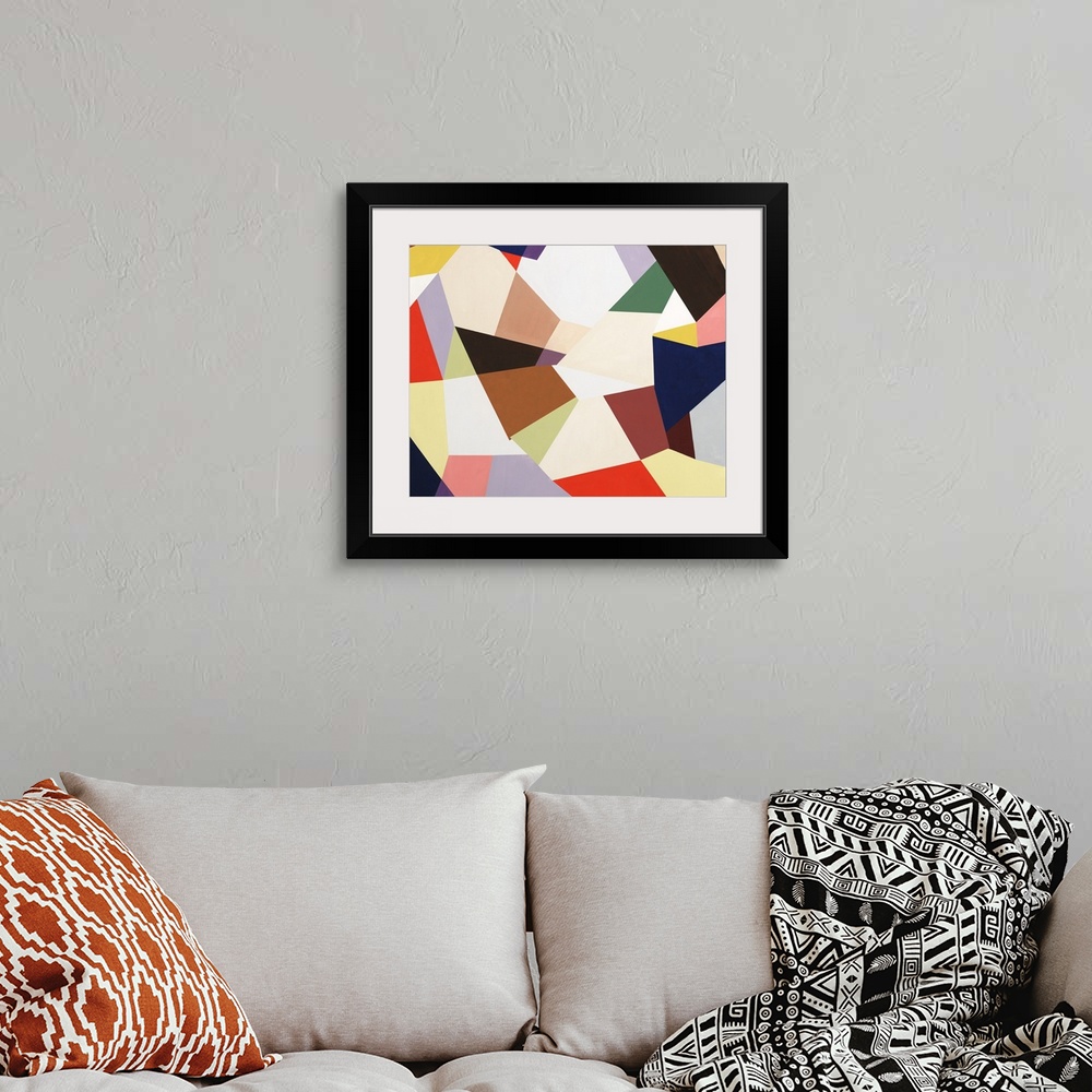 A bohemian room featuring Large abstract painting created with geometric shapes fitting together in various colors.