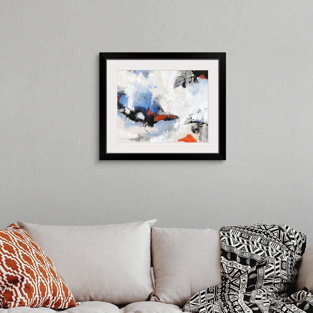 A bohemian room featuring Contemporary abstract painting with blue and red peeking through clouds of white.