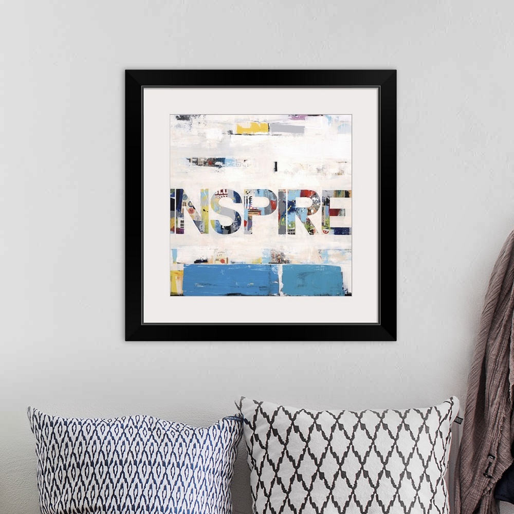 A bohemian room featuring Collage-style artwork of the word "inspire" in large block letters.