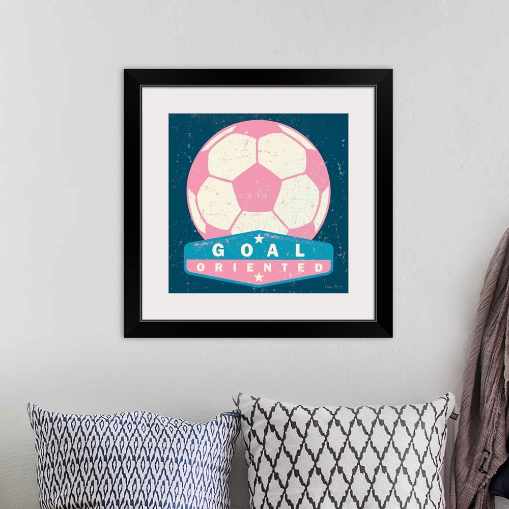 A bohemian room featuring Distressed large pink soccer ball with a typography saying "Goal Oriented"
