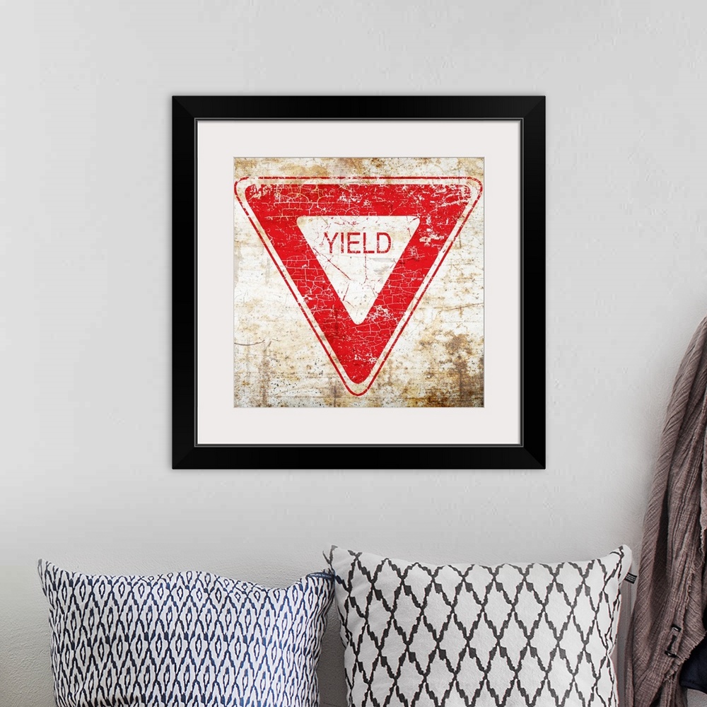 A bohemian room featuring A worn, distressed, cracked and rusty Yield street sign.