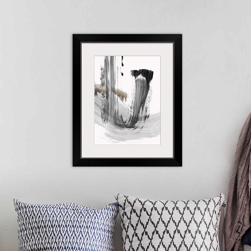 A bohemian room featuring vertical abstract painting with brush strokes of gray and black.