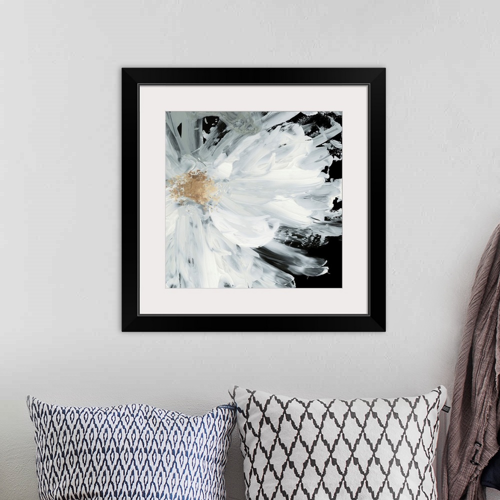 A bohemian room featuring Decorative artwork with a large white peony on a dark black background.