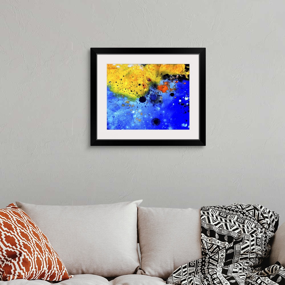 A bohemian room featuring Abstract painting of colors of blue, black and yellow with hints of red in textured brush strokes...