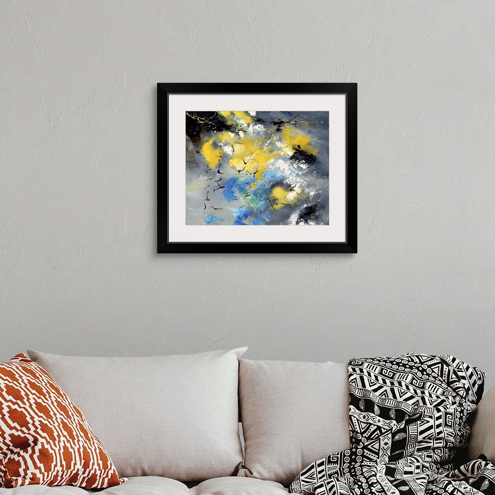A bohemian room featuring Abstract painting in shades of yellow, blue, gray and white mixed in with black contrasting designs.