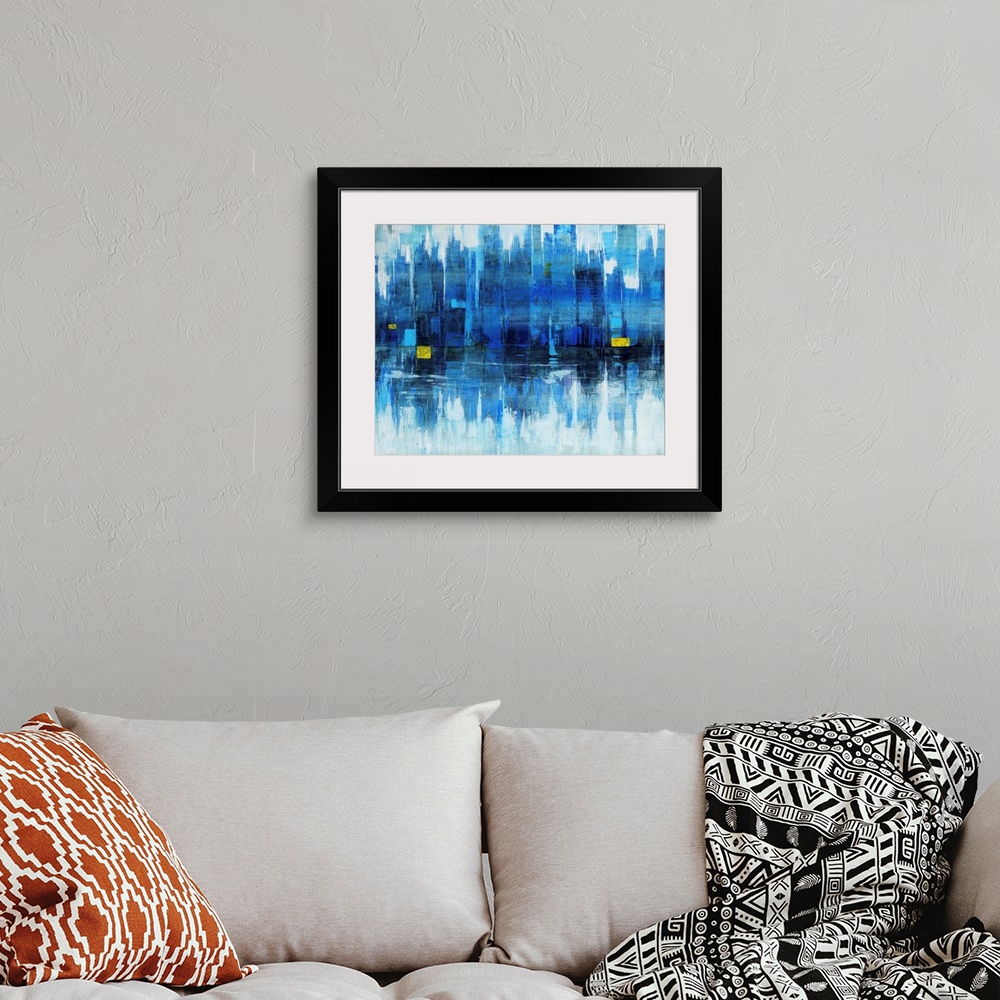 A bohemian room featuring Abstract modern art of a city skyline reflected off a body of water.