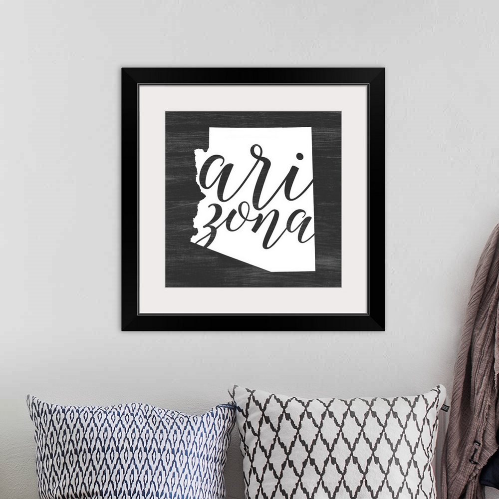 A bohemian room featuring Arizona state outline typography artwork.