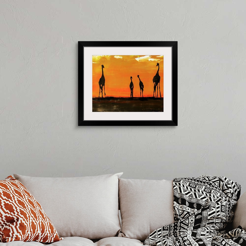 A bohemian room featuring Portrait of giraffes on the African plain in front of a vibrant, orange background.