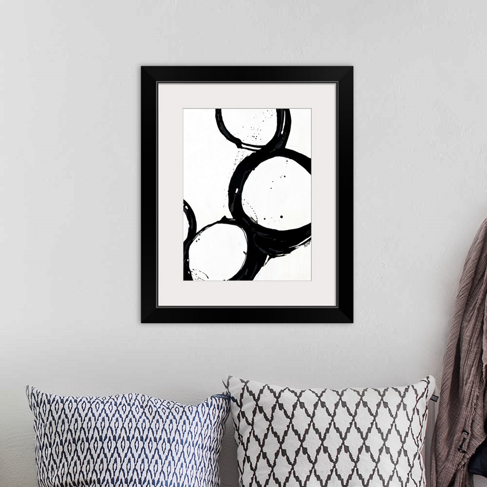 A bohemian room featuring Giant monochromatic abstract art includes a set of four uneven and irregular circles positioned n...