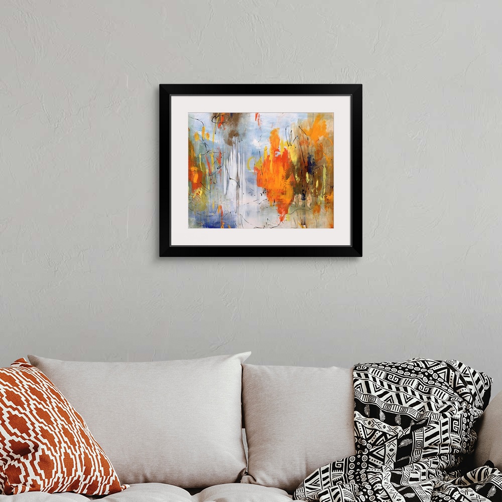 A bohemian room featuring Abstract painting of bright colors mixed with earth tones to create depth.
