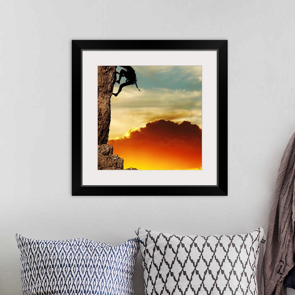 A bohemian room featuring girl climbing on the rock on sunset background