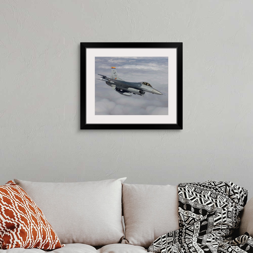 A bohemian room featuring An F-16 Fighting Falcon from the 162nd Fighter Wing maneuvers during a training mission out of Tu...