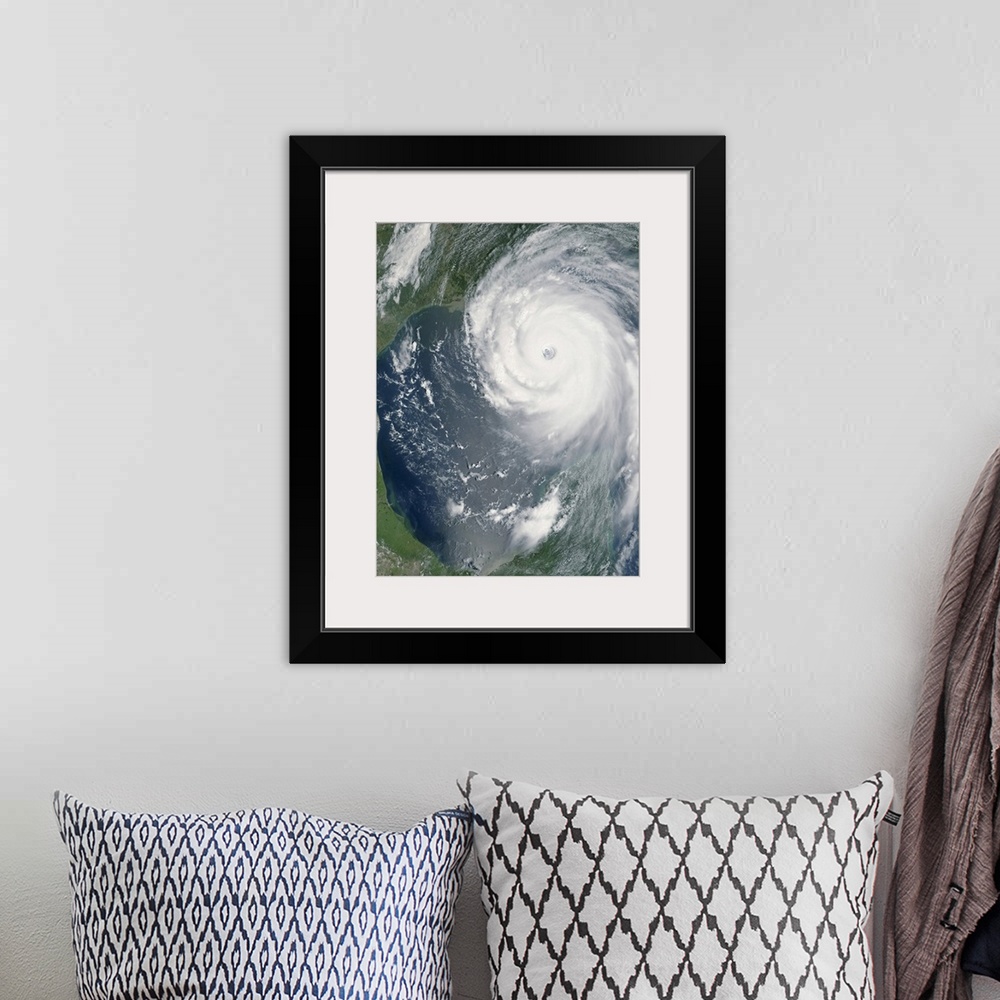 A bohemian room featuring Big, vertical, aerial photograph of Hurricane Katrina swirling as she approaches land.
