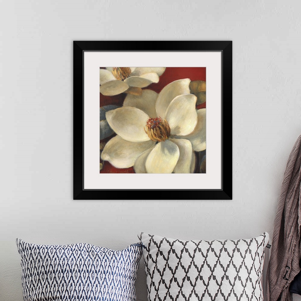 A bohemian room featuring Floral painting of several white magnolia flowers on a red background.