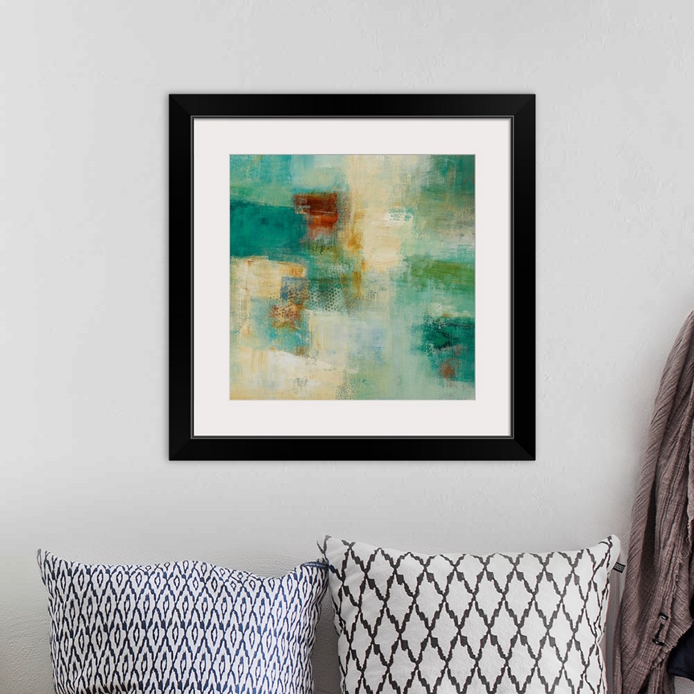 A bohemian room featuring Square abstract painting with warm and cool patches of color in rough textures.