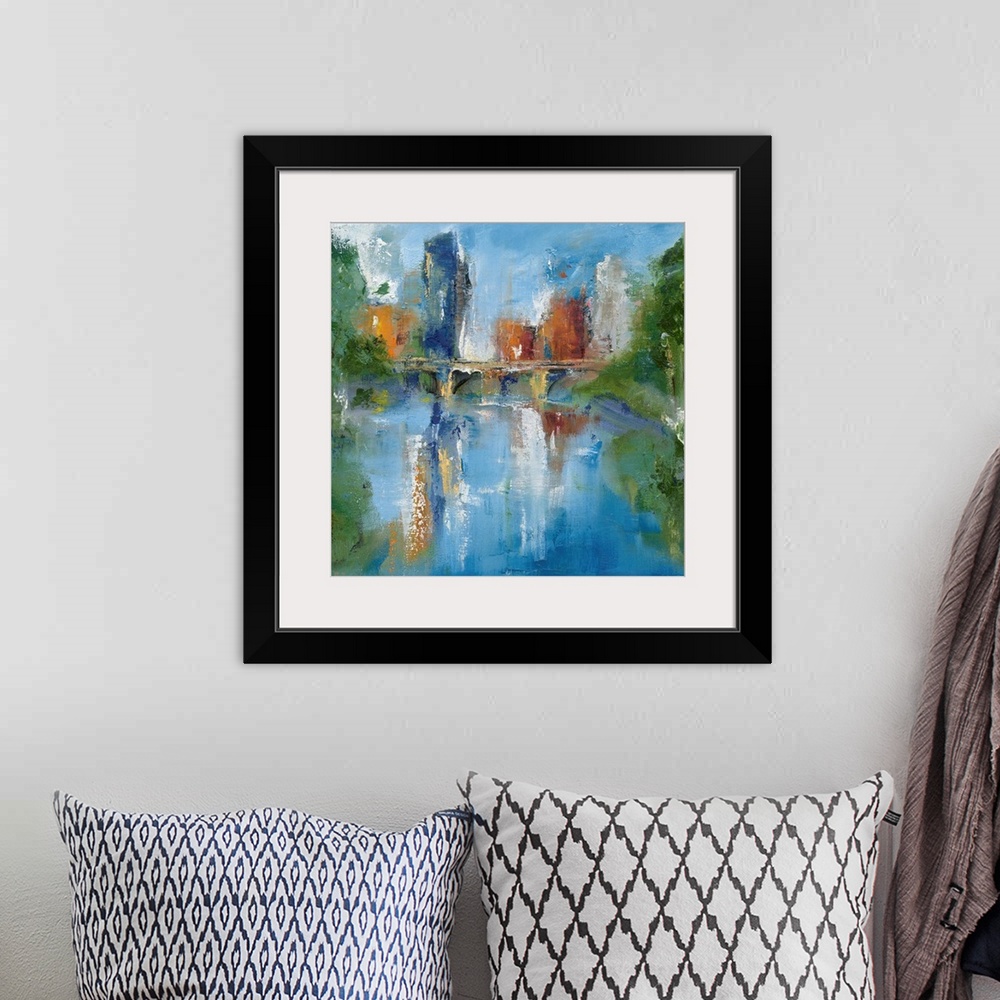 A bohemian room featuring Square abstract painting of a city skyline and a bridge reflecting into water with trees on the s...