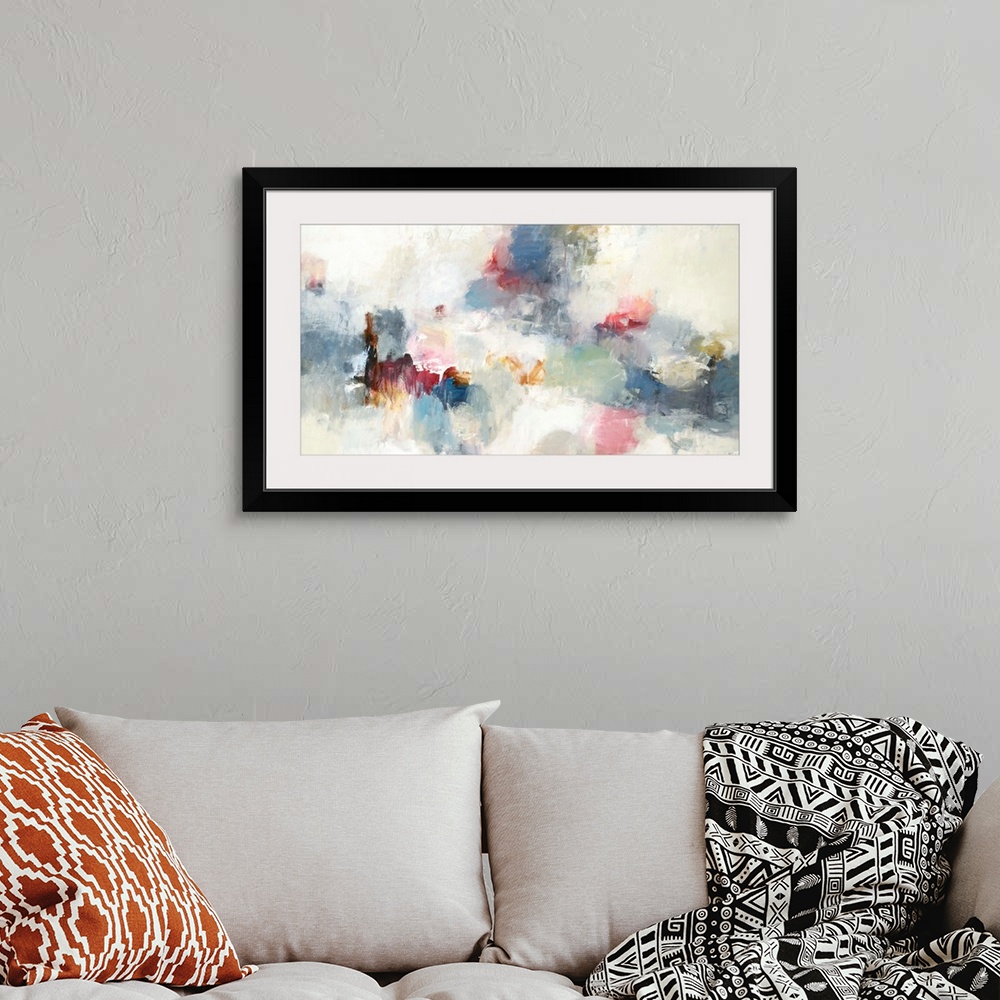 A bohemian room featuring Abstract painting made in shades of blue, red, cream, gray, yellow, and orange.