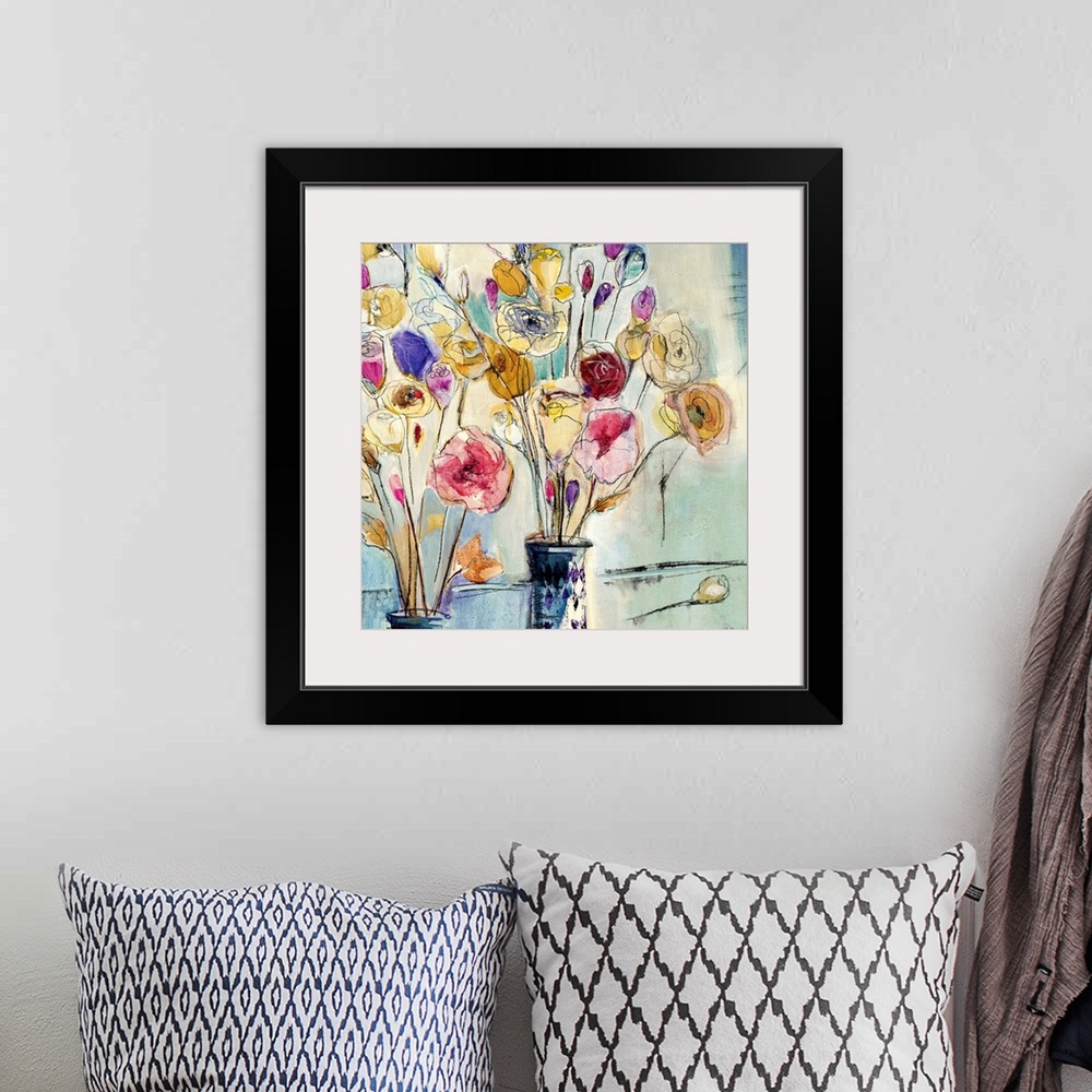 A bohemian room featuring Ink and watercolor artwork of flowers in vases printed on canvas.