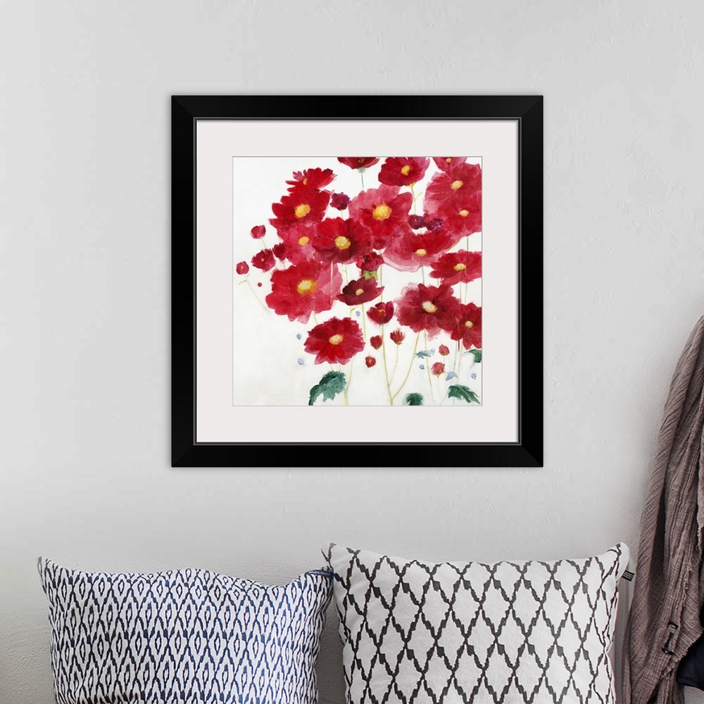 A bohemian room featuring A contemporary painting of vibrant red flowers against a white background.