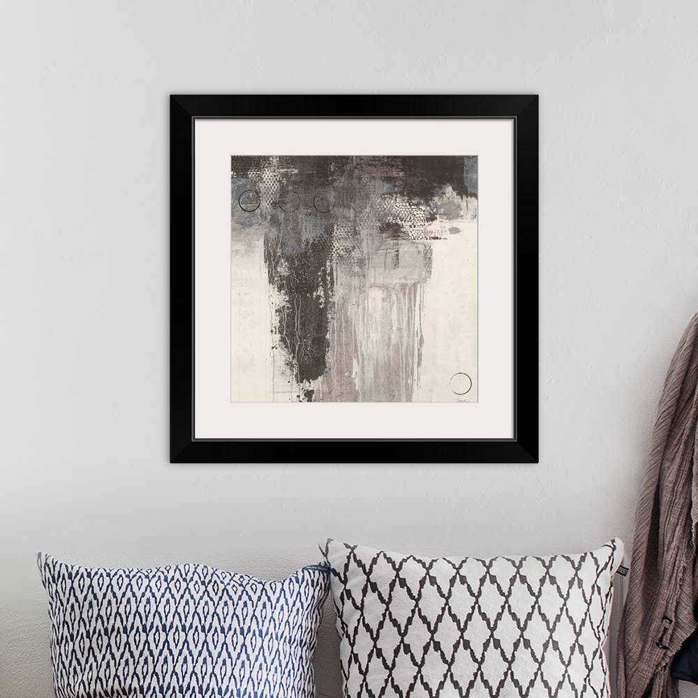 A bohemian room featuring A square abstract painting in varies tones of gray with thin black circles overlaying.