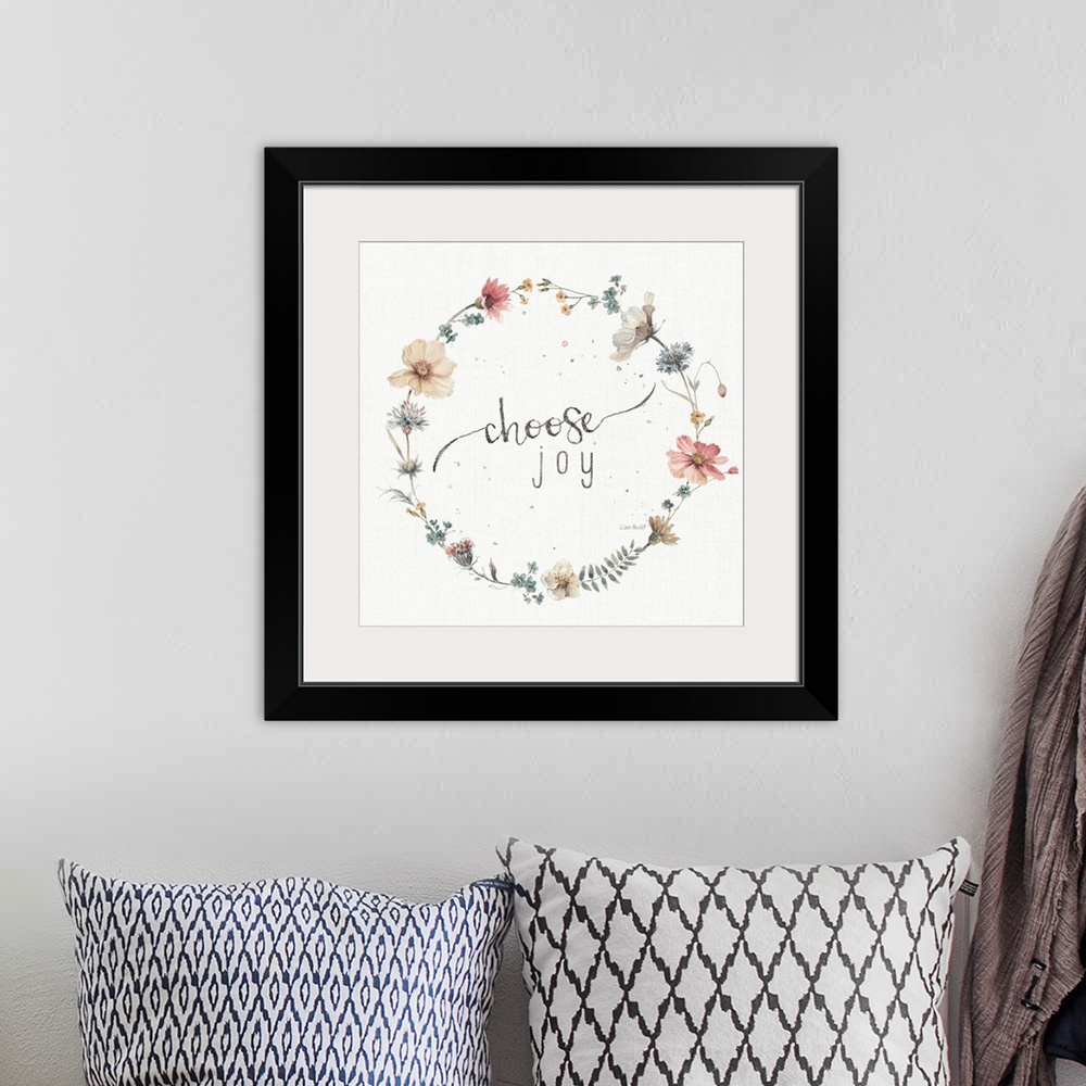 A bohemian room featuring Decorative artwork of a floral wreath with the words, choose joy, in the center.