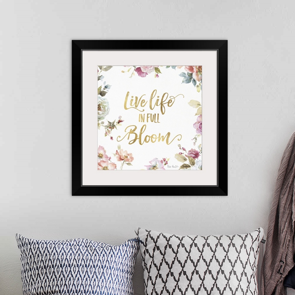 A bohemian room featuring "Live Life in Full Bloom" written in gold  and surrounded by a watercolor floral print.