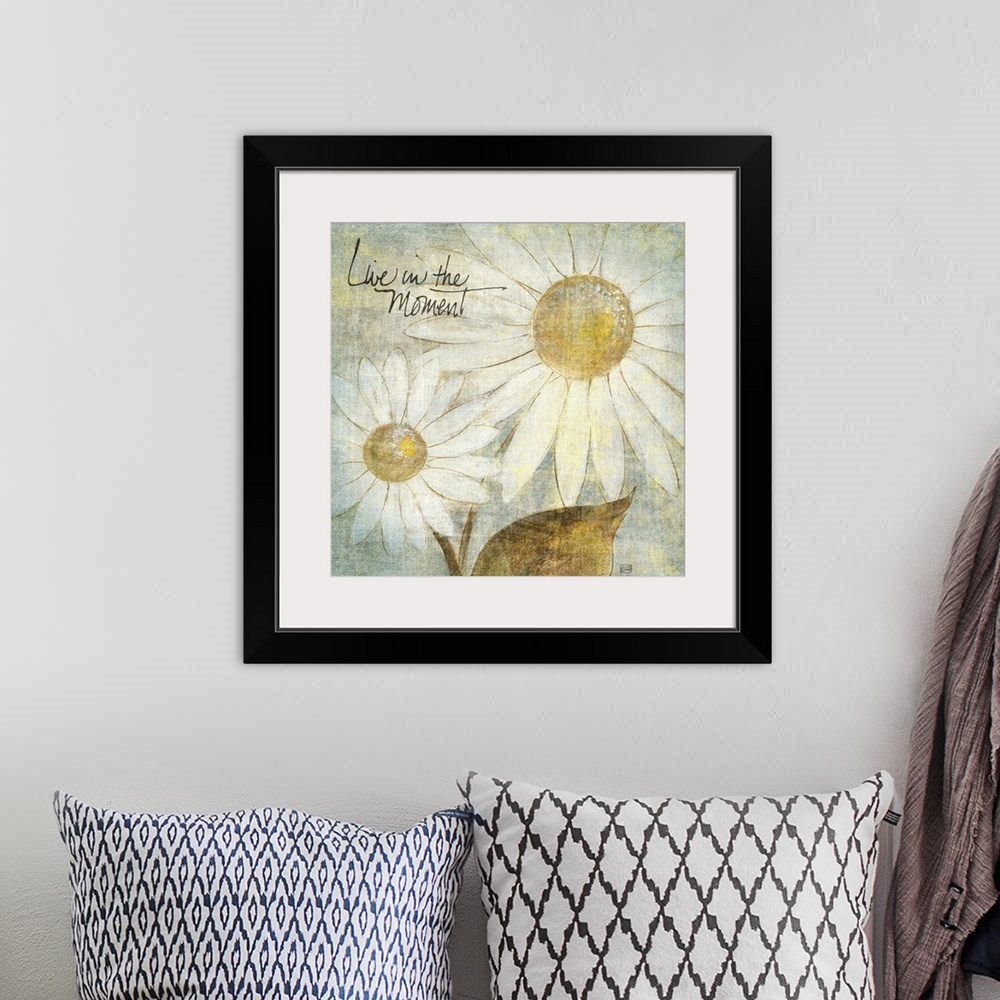 A bohemian room featuring A piece of artwork that contains two daisies and has a distressed look to the entire print. Text ...