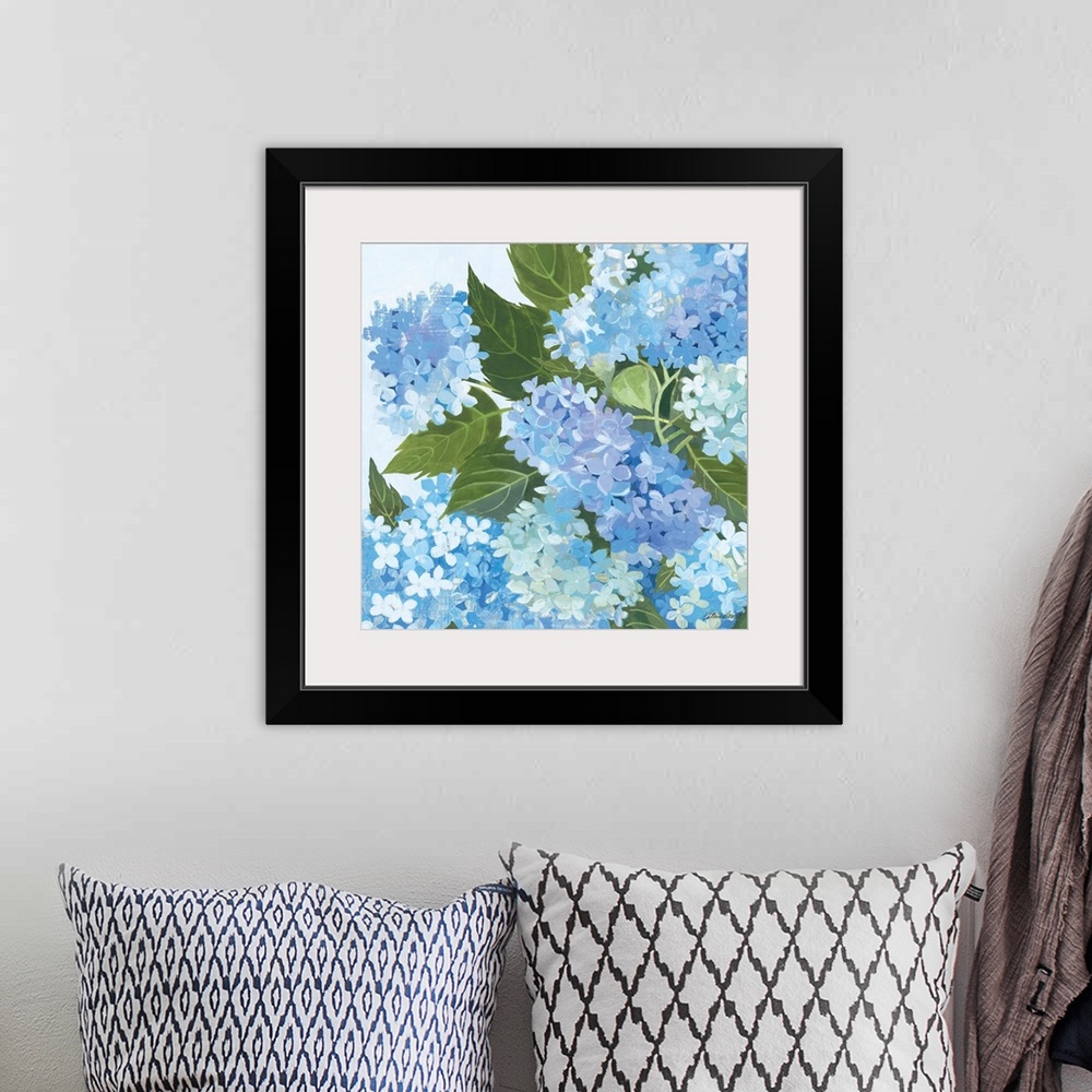 A bohemian room featuring Contemporary artwork of blue flowers close-up in the frame of the image.