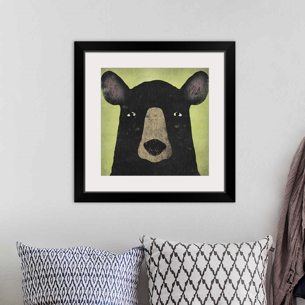 A bohemian room featuring Portrait of a black bear with big ears and an intense stare.