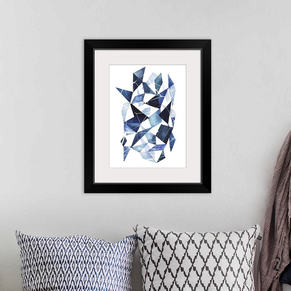 A bohemian room featuring Abstract watercolor geometric artwork in shades of blue.