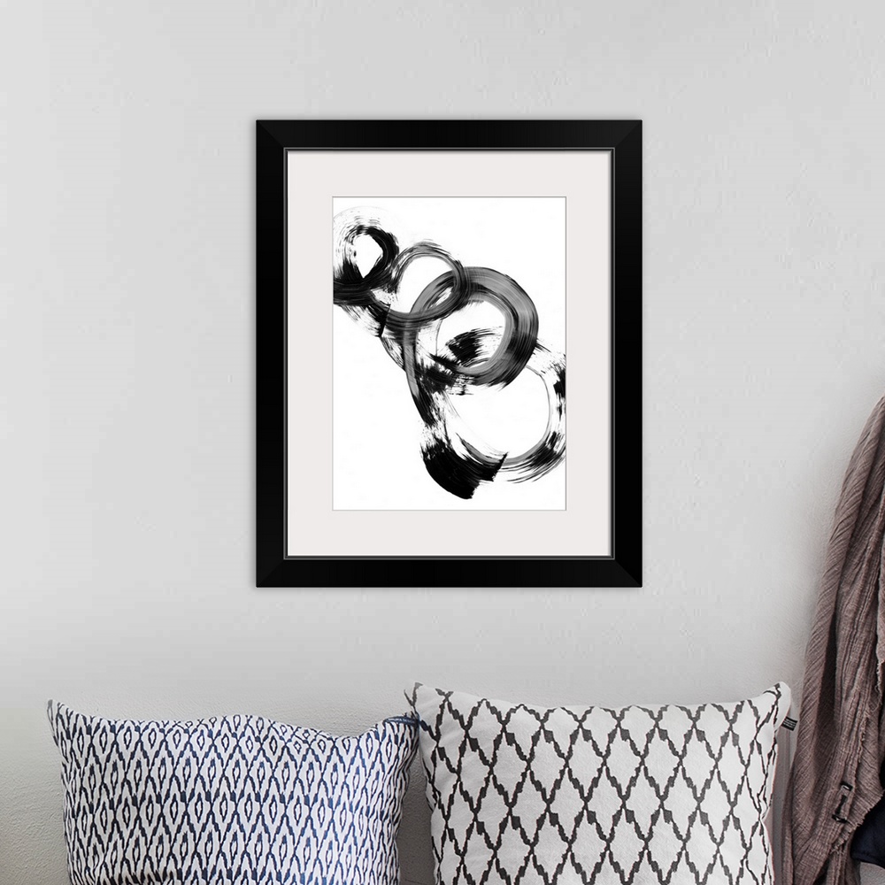 A bohemian room featuring Contemporary abstract painting of interlocking circular shapes in black and white.
