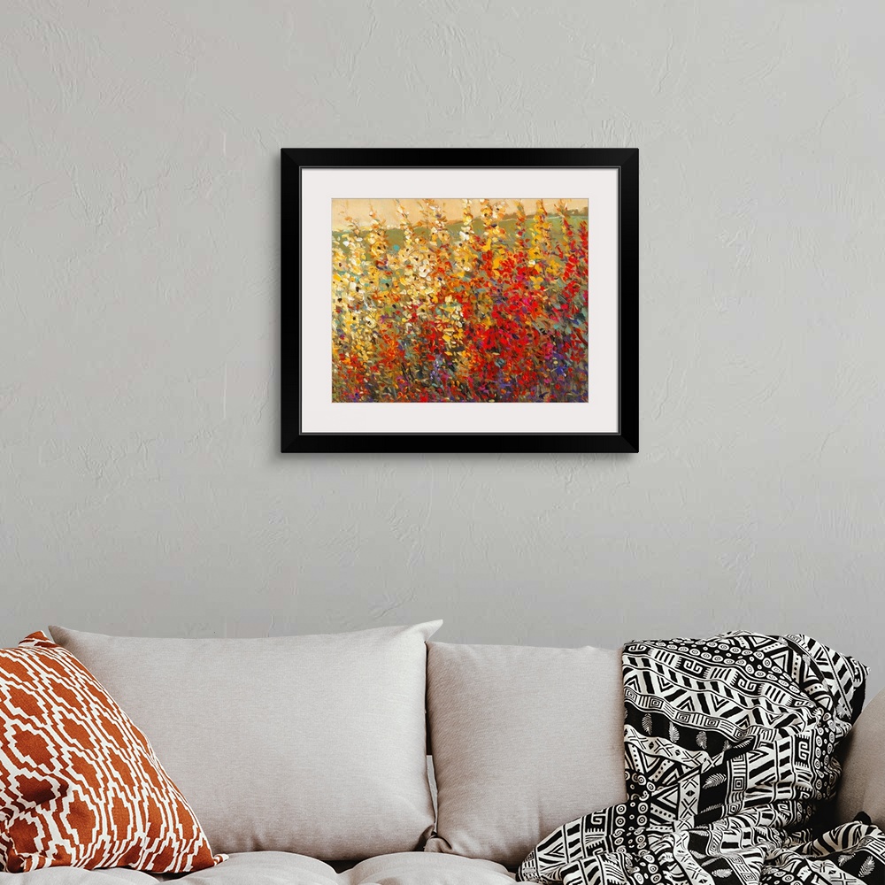 A bohemian room featuring A glorious tangle of wildflowers in warm yellow and red tones. This modern painting in the impres...