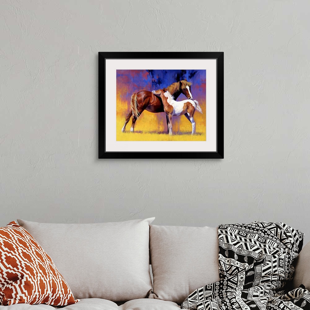 A bohemian room featuring Big painting on canvas of a baby horse cuddling with an adult horse.