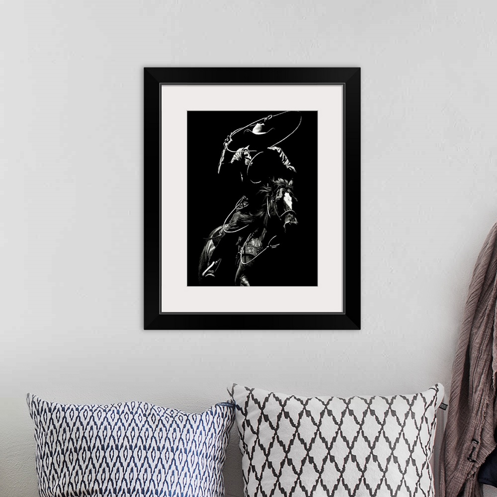 A bohemian room featuring Black and white lifelike illustration of a cowboy riding a horse with a lasso.