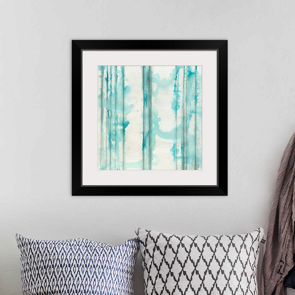 A bohemian room featuring Square abstractly painted canvas of vertical lines with splattered watercolor paint on top.