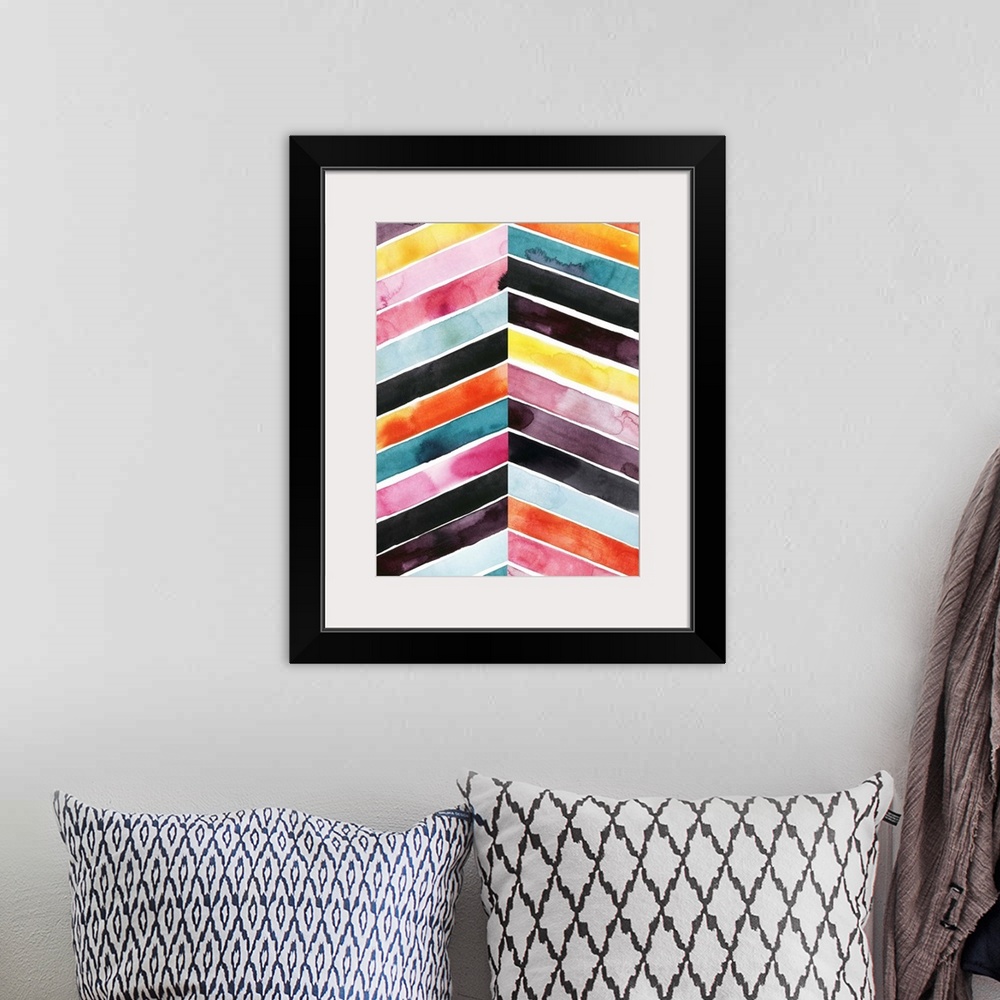 A bohemian room featuring Chevron striped watercolor painting in vivid red, pink, blue, and yellow contrasting with black.