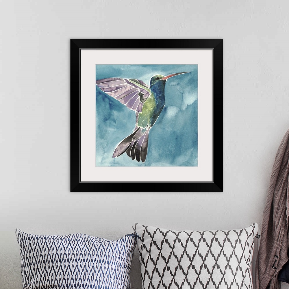 A bohemian room featuring Watercolor painting of a hummingbird against a blue background.