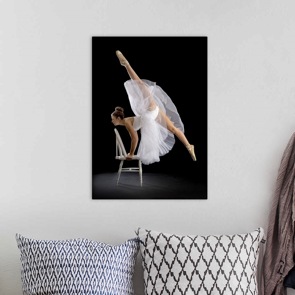 A bohemian room featuring A ballerina posing on a chair with one leg high in the air.