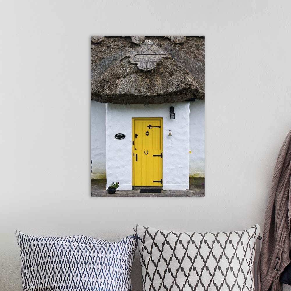 A bohemian room featuring Ireland, Achill Island. Yellow doorway on a thatch roof cottage.
