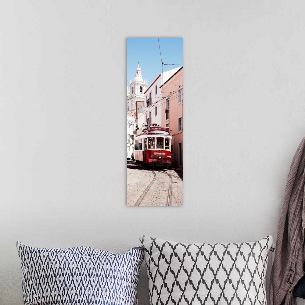 A bohemian room featuring It's a typical Lisbon street with a church and colorful Facades and the red tram in Portugal.