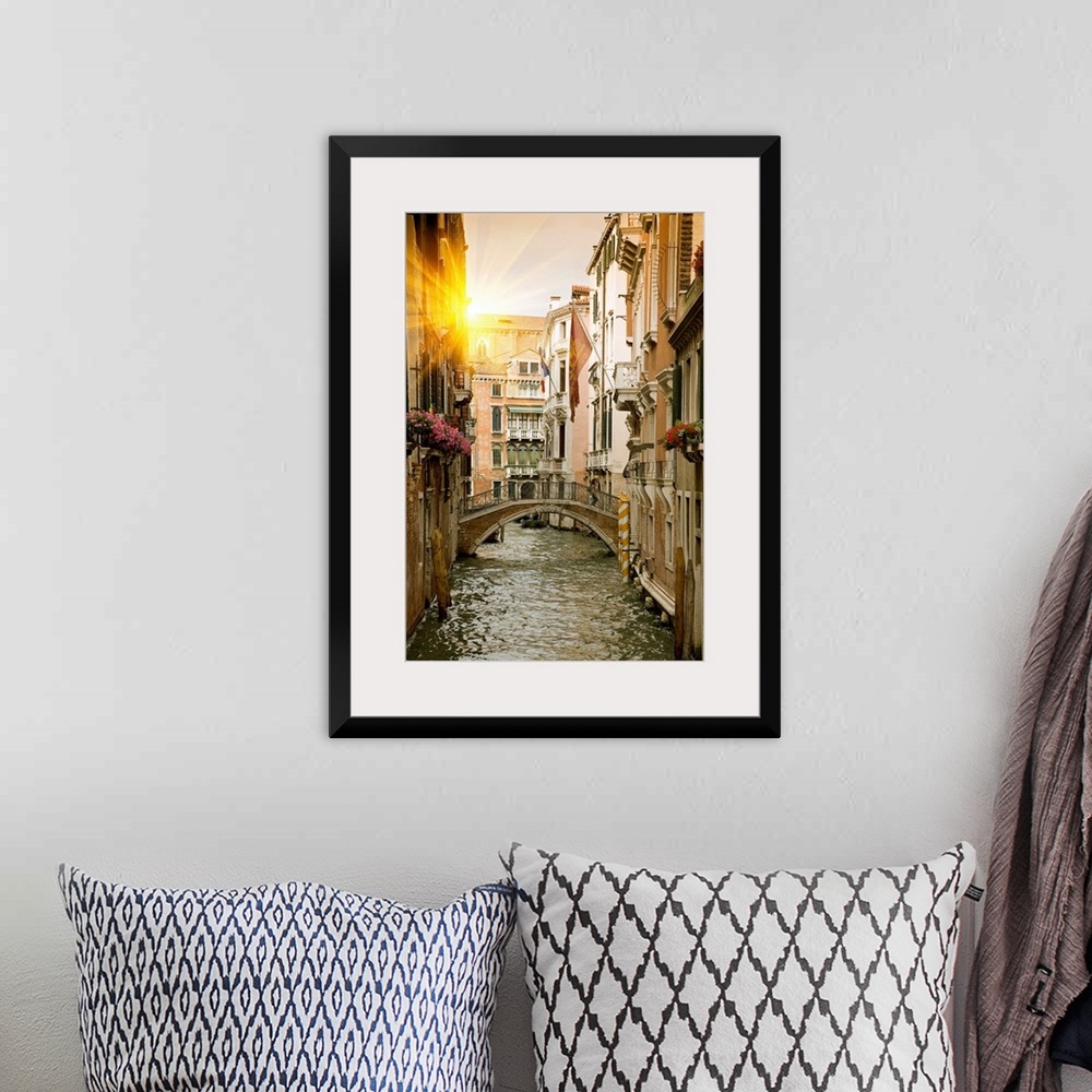 A bohemian room featuring Large portrait wall hanging of buildings and a bridge in a canal in Venice, Italy.