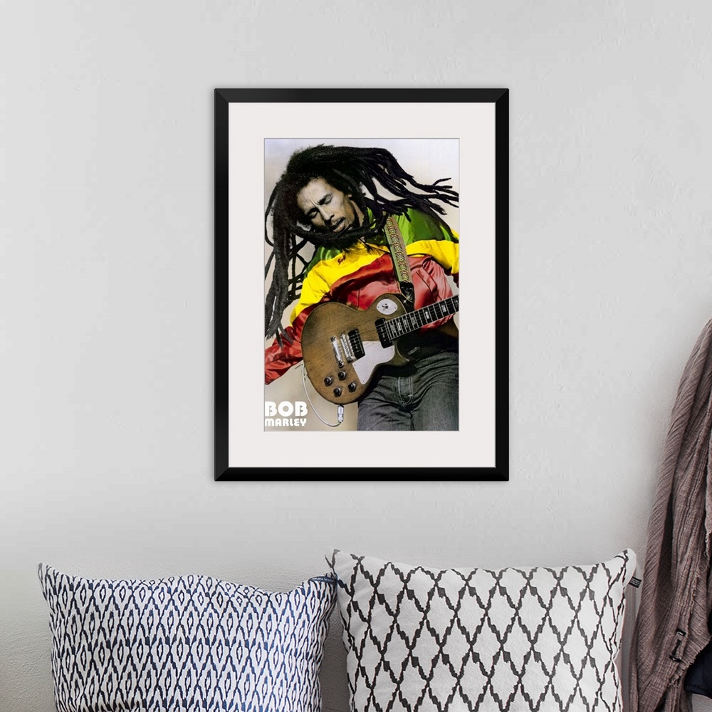 A bohemian room featuring Large, portrait photograph of Bob Marley playing guitar, his name in the bottom left corner.