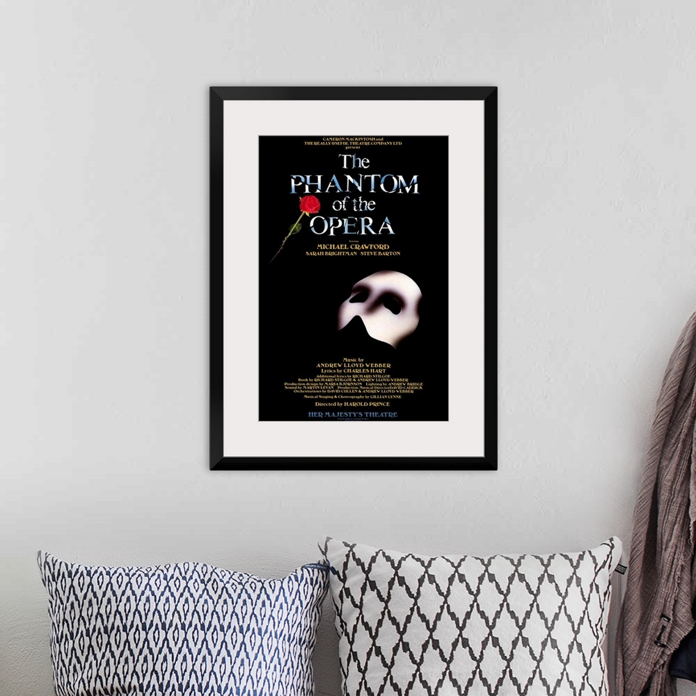 A bohemian room featuring Broadway poster for Andrew Lloyd Webber's play, The Phantom of the Opera, displaying the Phantom'...