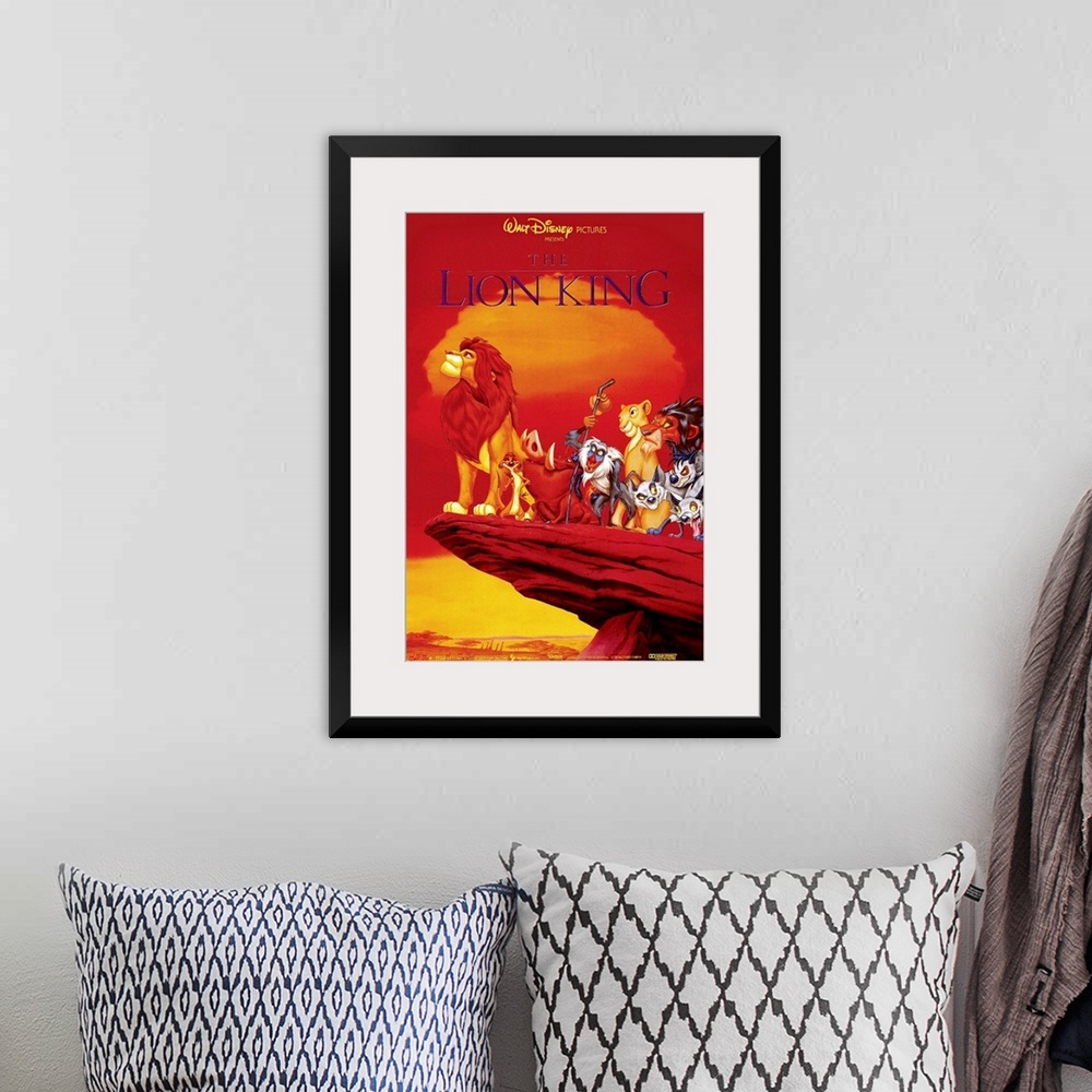 A bohemian room featuring Large, vertical movie advertisement of the Walt Disney movie, The Lion King.  A grown Simba peers...