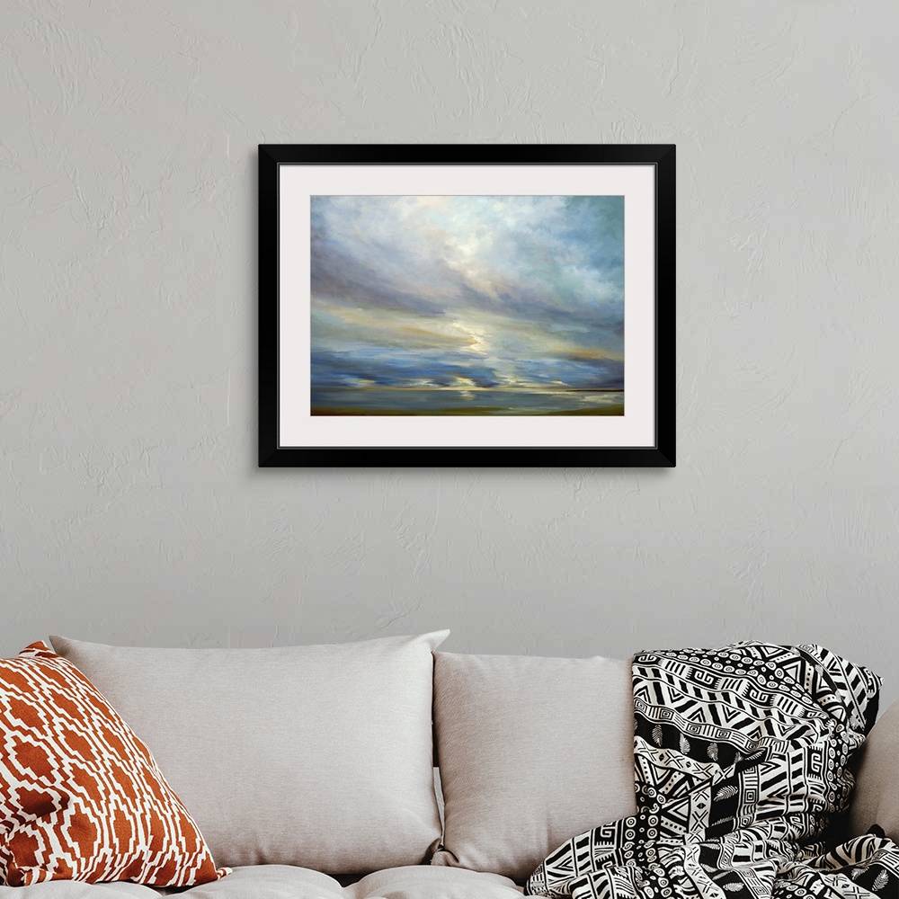 A bohemian room featuring Contemporary seascape painting of sunlight shining though clouds over the ocean.