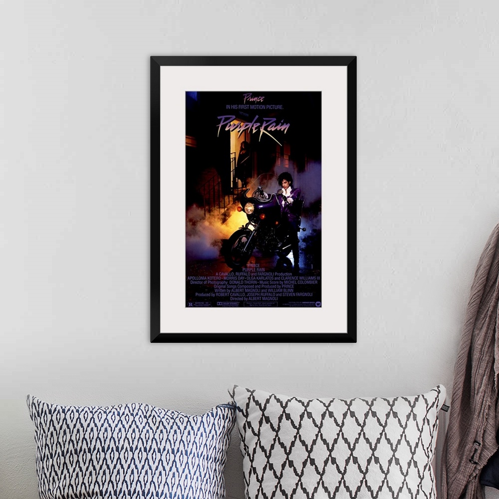 A bohemian room featuring Vintage movie poster for the movie Purple Rain featuring the music artist Prince with a picture o...