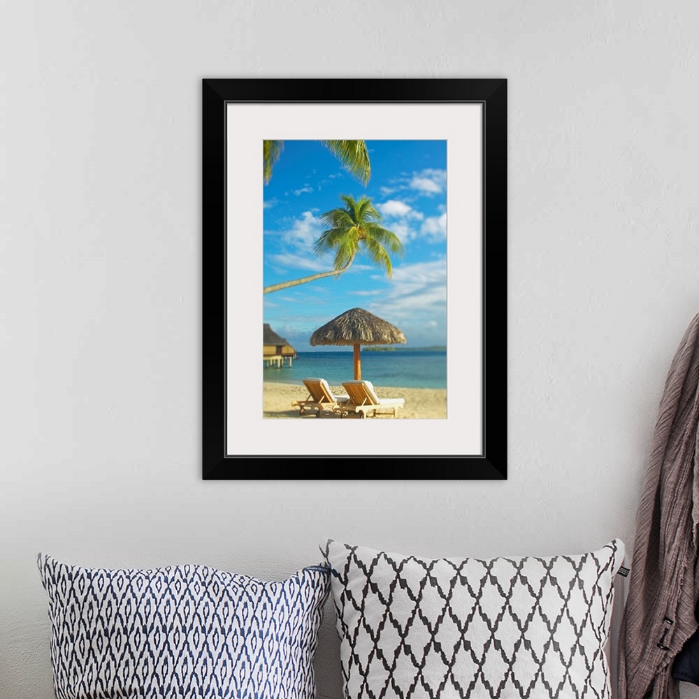 A bohemian room featuring Photograph taken of two beach chairs and an umbrella sitting on a beach in Tahiti. A palm tree st...